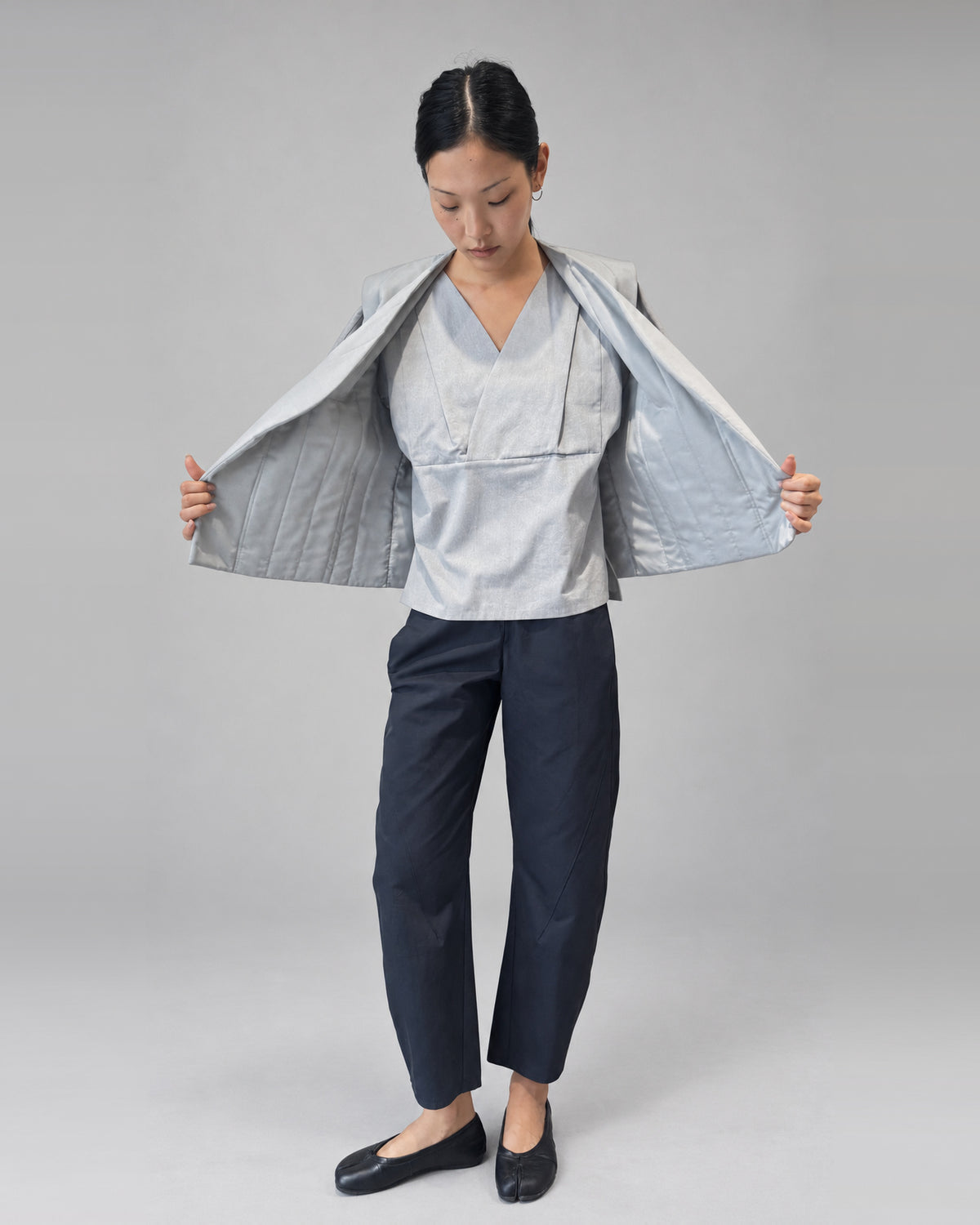 Anujin wearing Nubi Vest Classic, City Grey — open front.