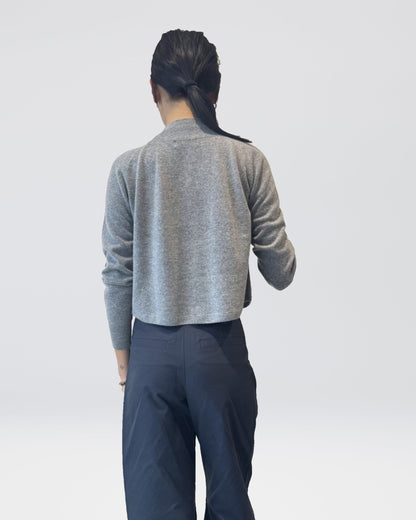 Anujin wearing High Neck Cardigan, Melange Grey, with Twist Pants Berge — back view.
