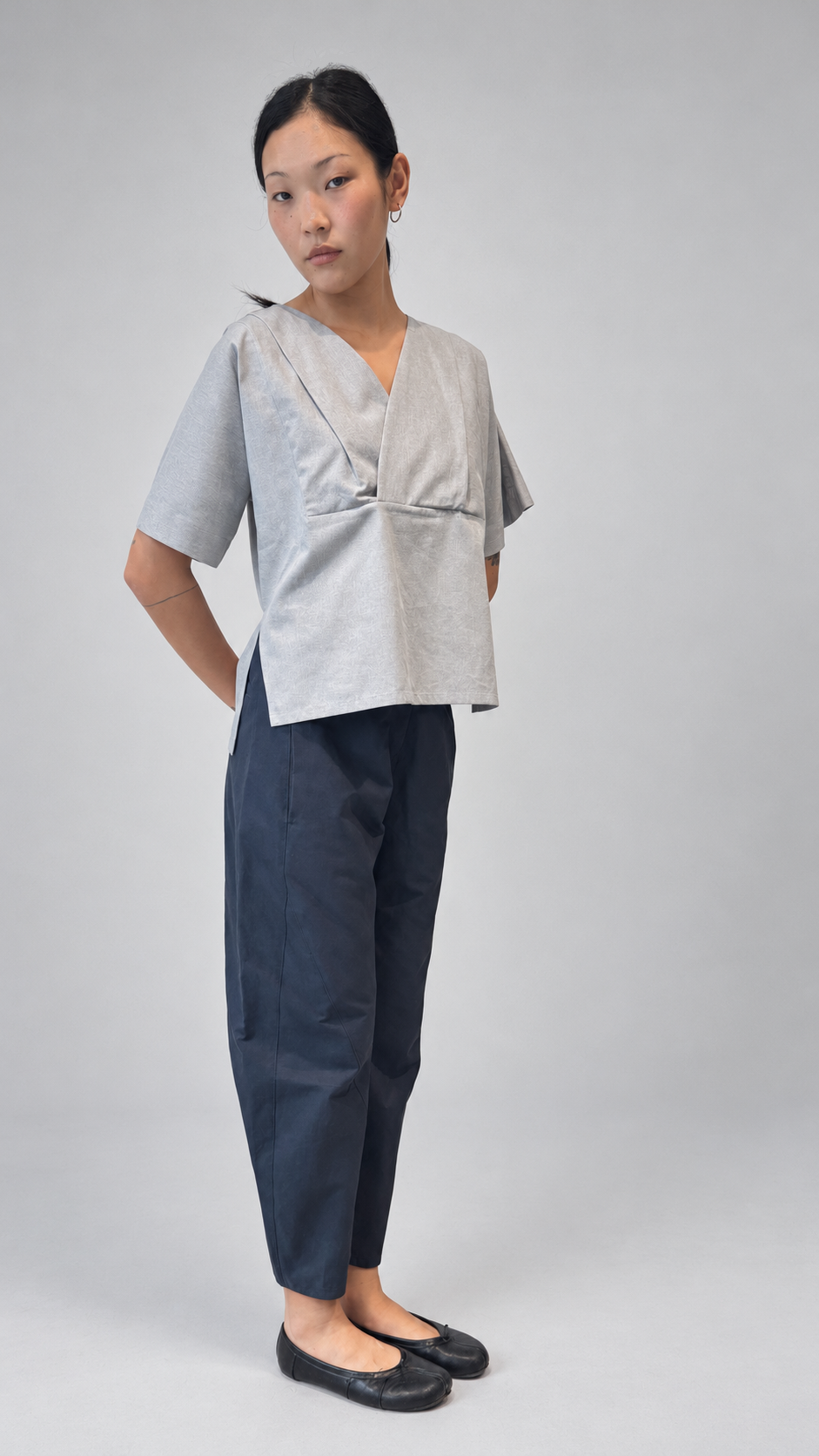 Lotus Shirt, Temple Grey — detail or alternate model view. Anujin wearing lotus shirt temple grey, twist pants berge.