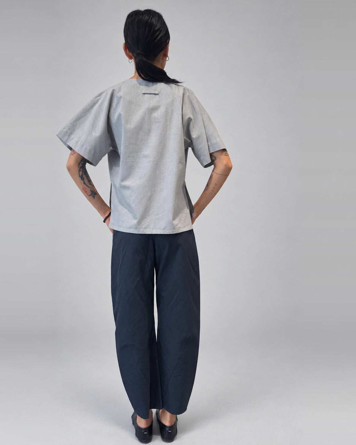 Anujin wearing Lotus Shirt, Temple Grey — back.