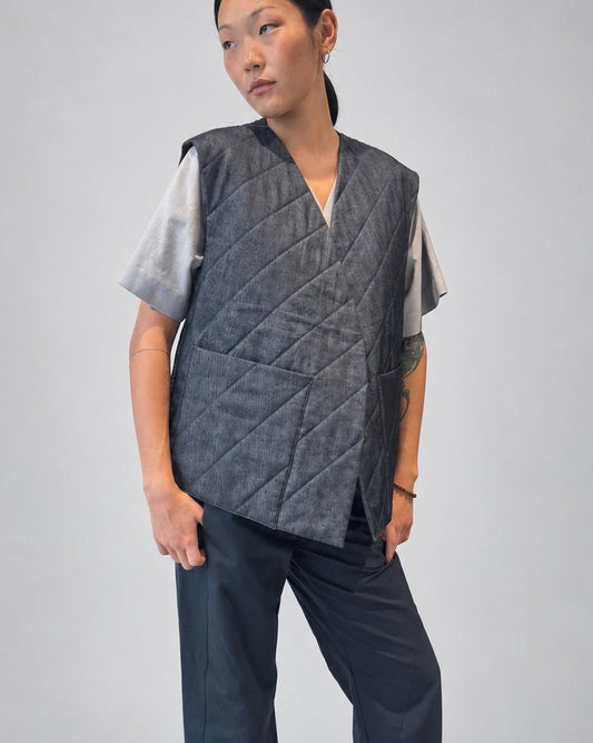 Anujin wearing Nubi Vest Wide, Dark Denim (Mens Fit) — three-quarter front.