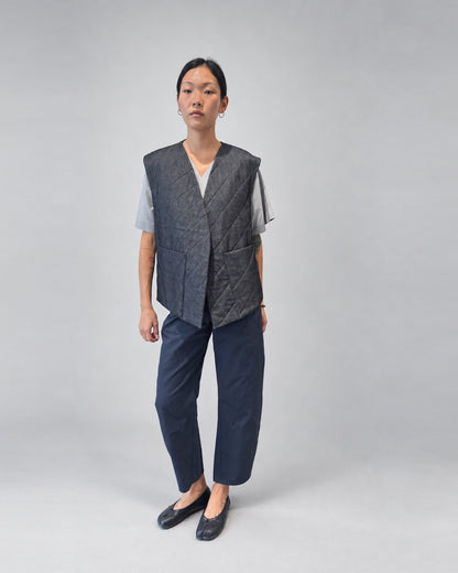 Anujin wearing Nubi Vest Wide, Dark Denim (Mens Fit) — front.