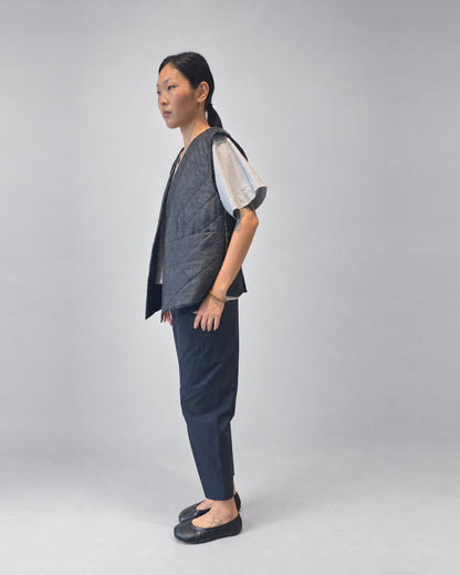 Anujin wearing Nubi Vest Wide, Dark Denim (Mens Fit) — side.