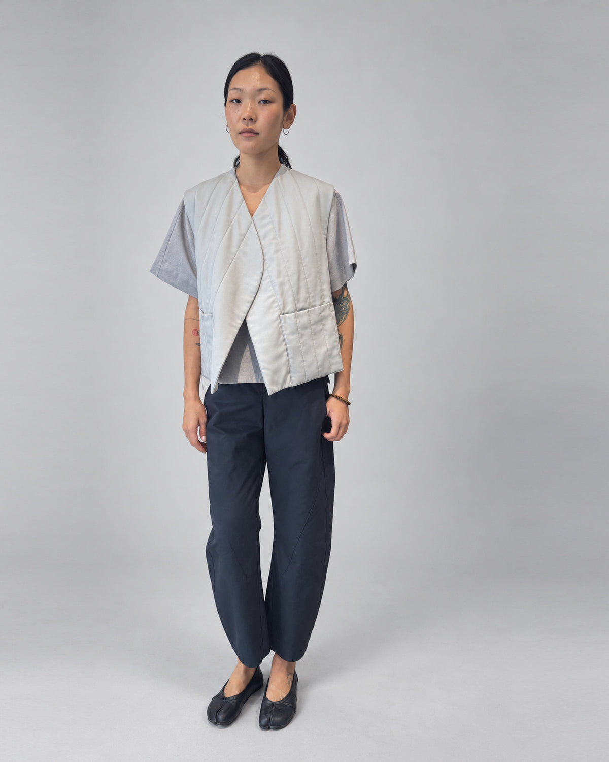 Anujin wearing Nubi Vest Classic, City Grey — front.
