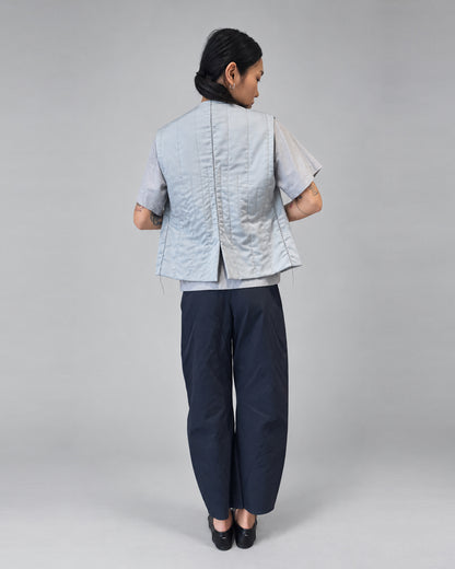 Anujin wearing Nubi Vest Classic, City Grey — back.