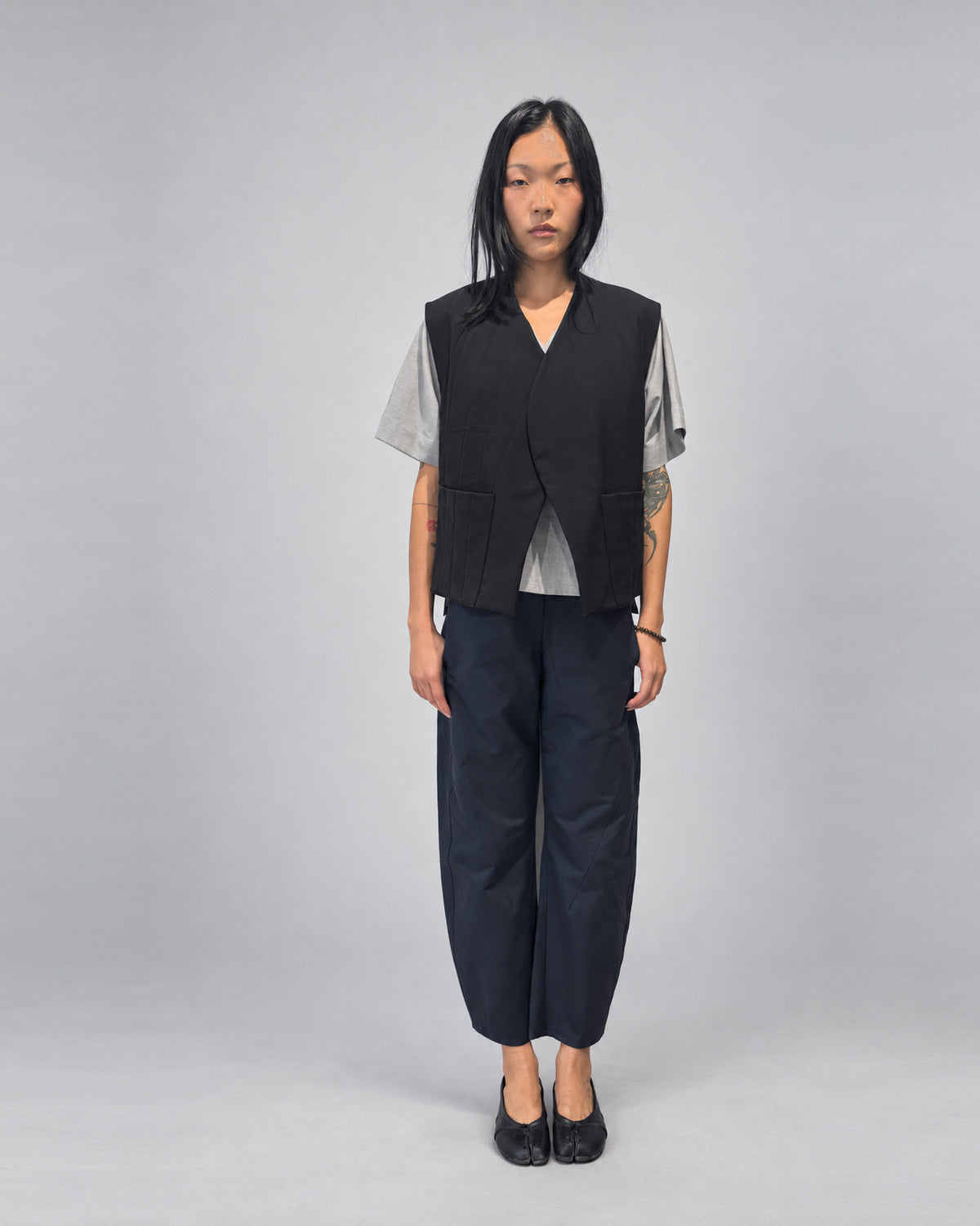 Anujin wearing Nubi Vest Classic, Black Wool — full-length front.