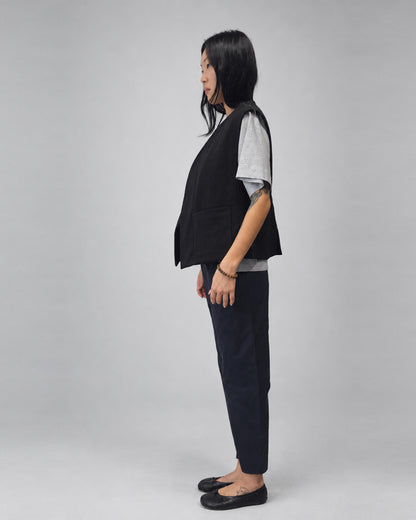 Anujin wearing Nubi Vest Classic, Black Wool — full-length side.