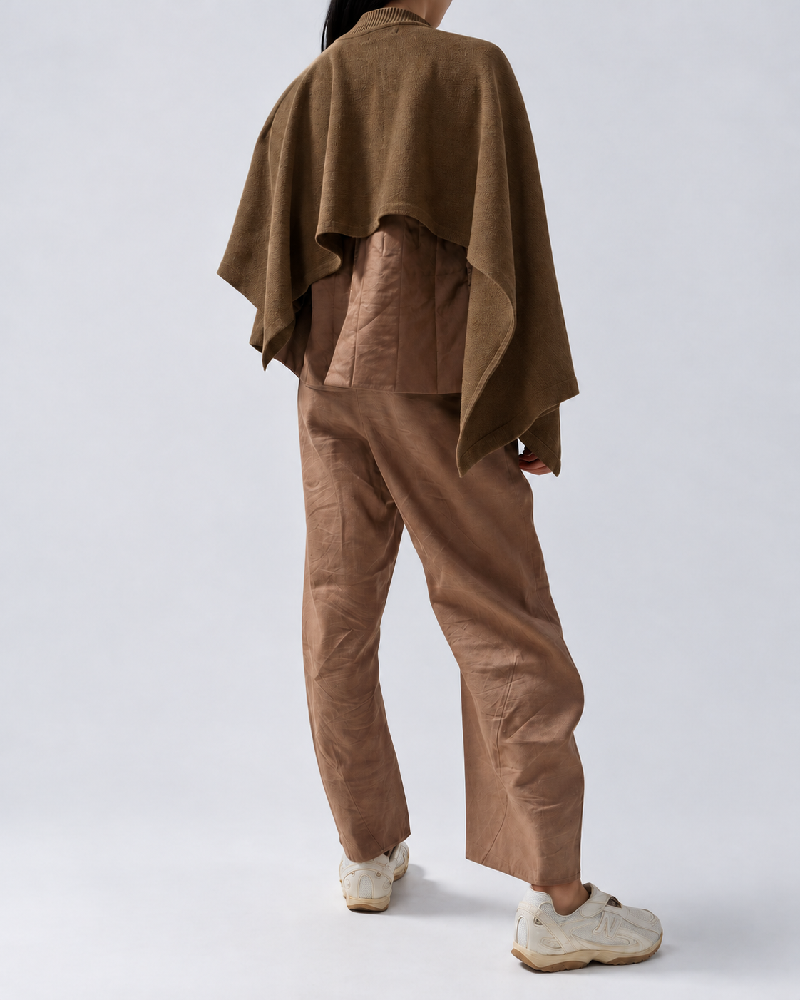Draped Knit Shawl in Brown worn on a model, rear three-quarter view