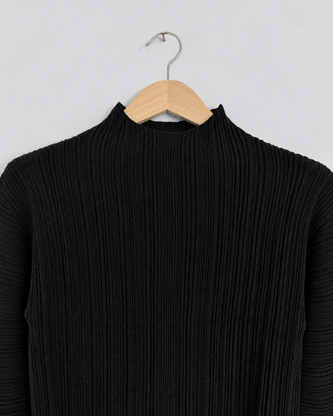 NINA YUUN Wool-Cotton Pleated Pullover in black — close-up of the high neckline and fine vertical pleated knit texture.