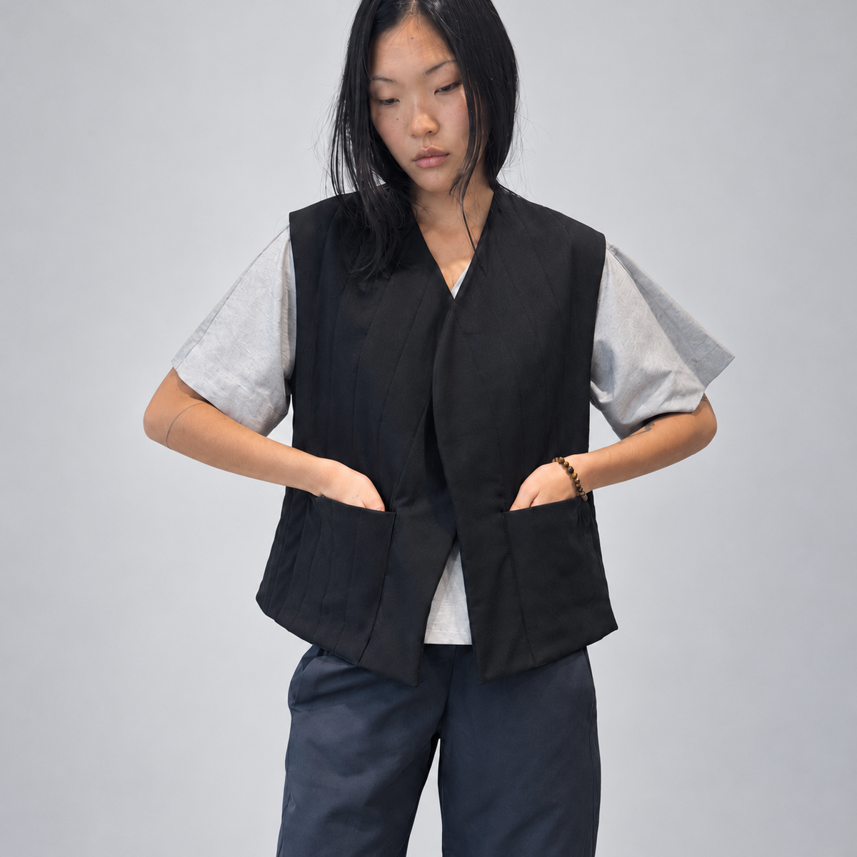 Nubi Vest Classic in Black Wool, editorial front detail with hands in pockets