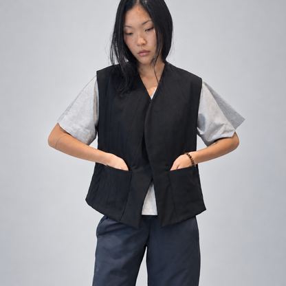 Nubi Vest Classic in Black Wool, editorial front detail with hands in pockets